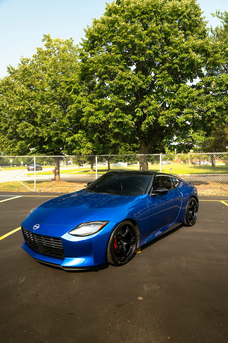 Blue Nissan Z coupe in a parking lot