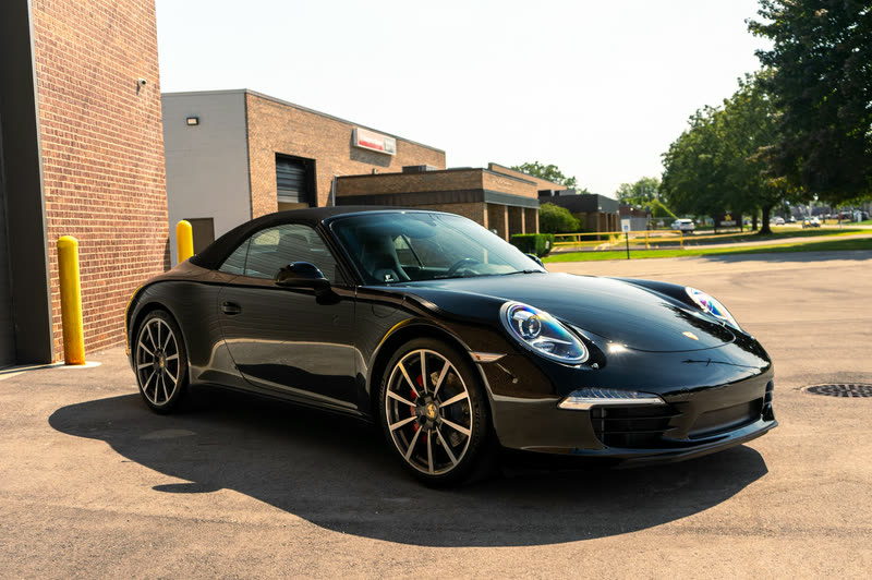 Black Porsche 911 on an asphalt lot