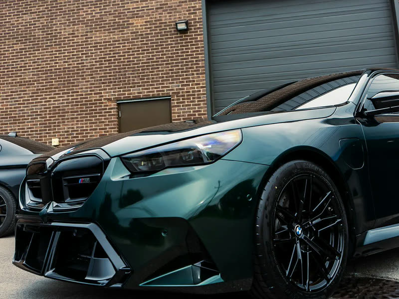 Ceramic Coating in Livonia, MI: dark green BMW M5, front corner view