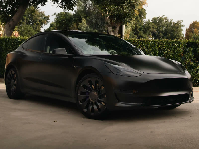 Tesla paint protection film: black Tesla parked outside a house